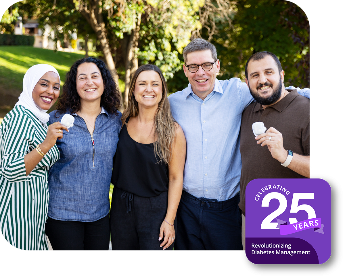 Group of Insulet employees at a park with a 25 Year Anniversary badge at the bottom right