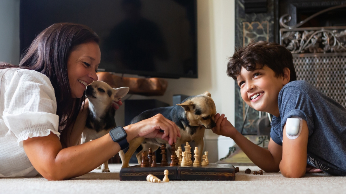 Mon and son playing chess together