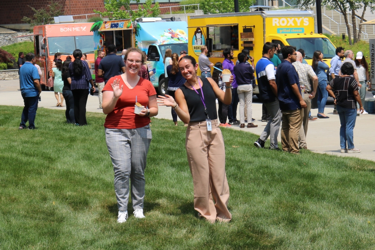 Food trucks at Insulet Corporation's headquarters with two employees standing in front