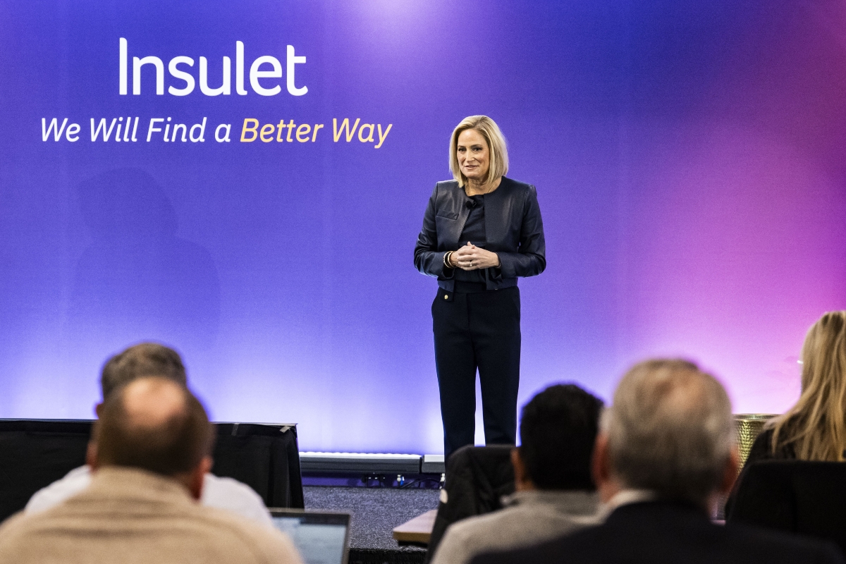Insulet's CEO, Ashley, standing in front of a stage speaking to an audience