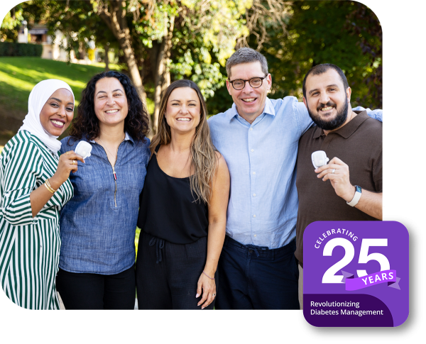 Group of Insulet employees at a park with a 25 Year Anniversary badge at the bottom right
