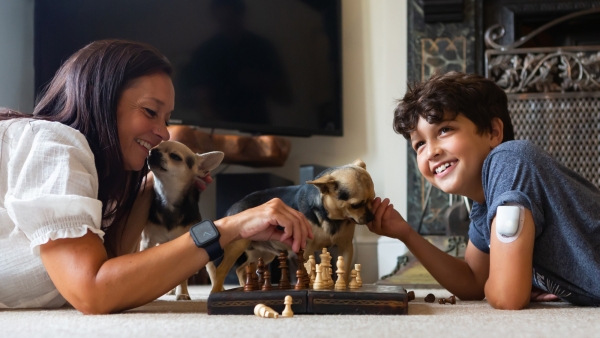 Mon and son playing chess together