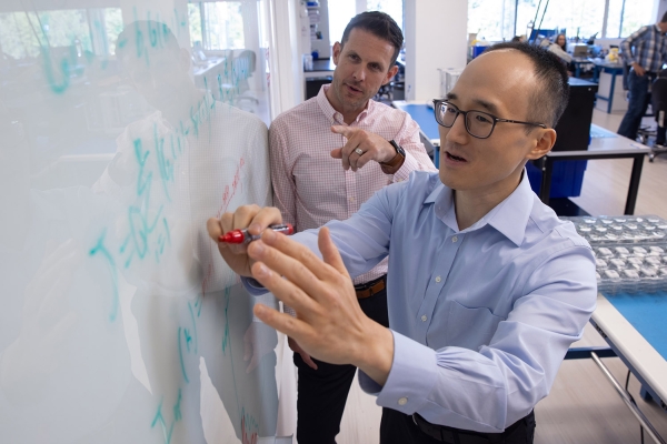 Insulet employees designing on a white board