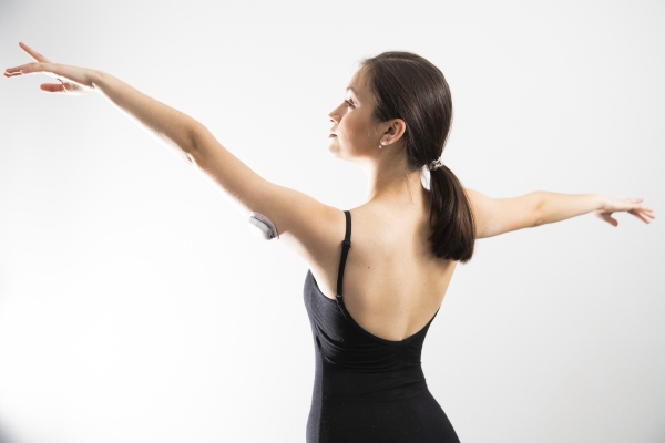 A woman practicing ballet with an Omnipod on her arm