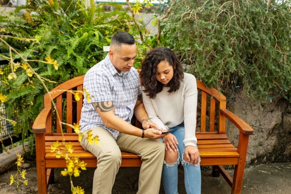 A father and his daughter on a park bench