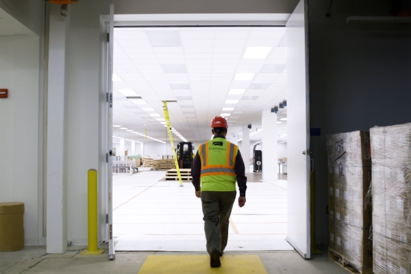 A warehouse worker surveys the floor