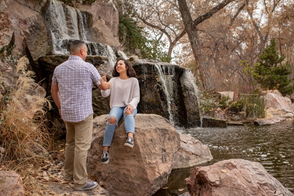 A couple enjoying time outdoors near a waterfall