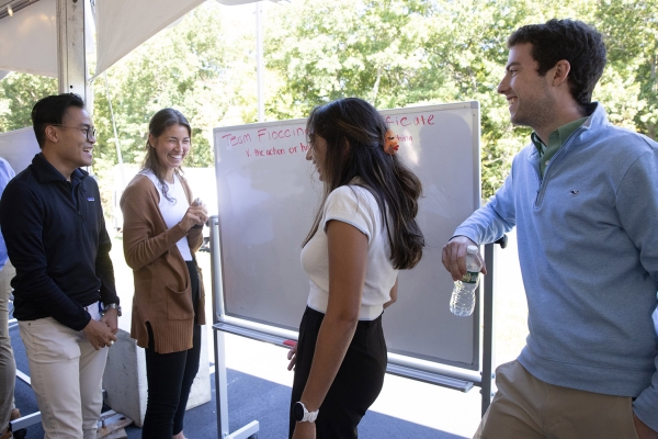 Employees at a white board at an off-site gathering