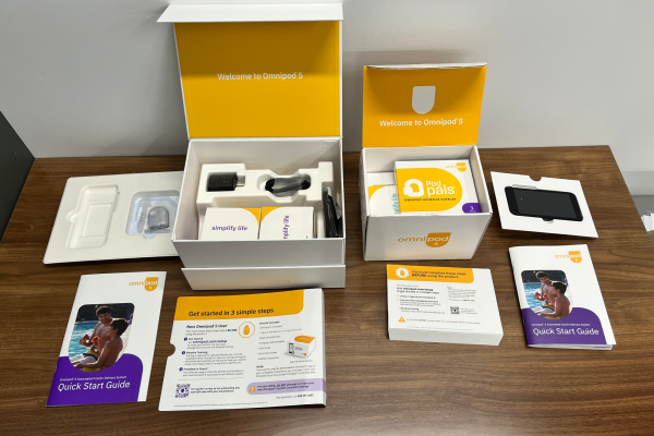 Omnipod packaging boxes on a wooden table on display