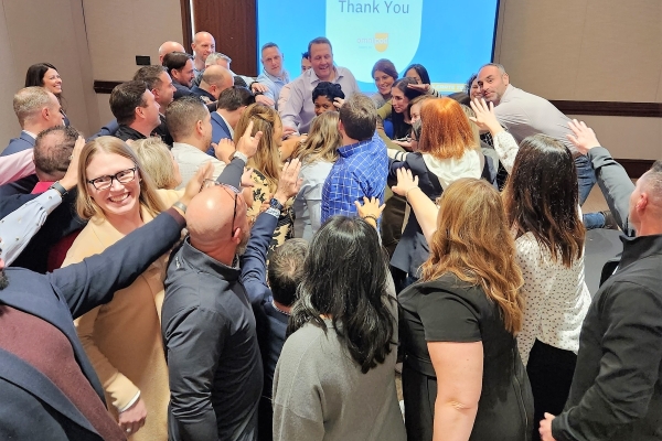 Group of employees putting hands together in celebration