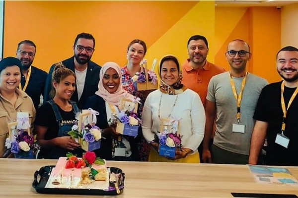 Group of Insulet employees standing by table for celebrating DEI