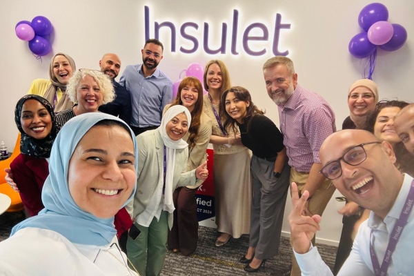 Insulet ME team selfie with the Insulet logo in the background