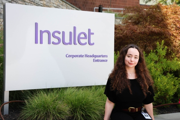 Insulet intern, Ashley Clemon, standing in front of Insulet sign