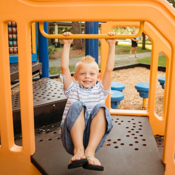 A young boy showing his Omnipod while playing outside