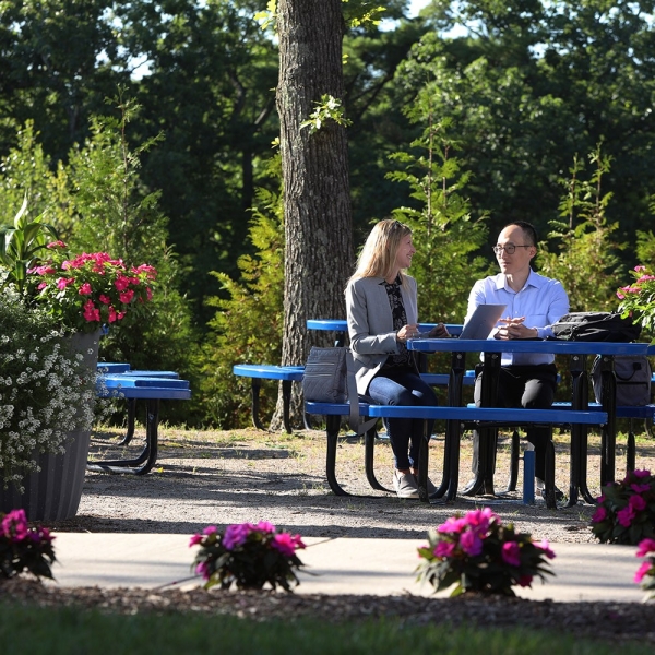 Insulet employees have a meeting outside in a courtyard