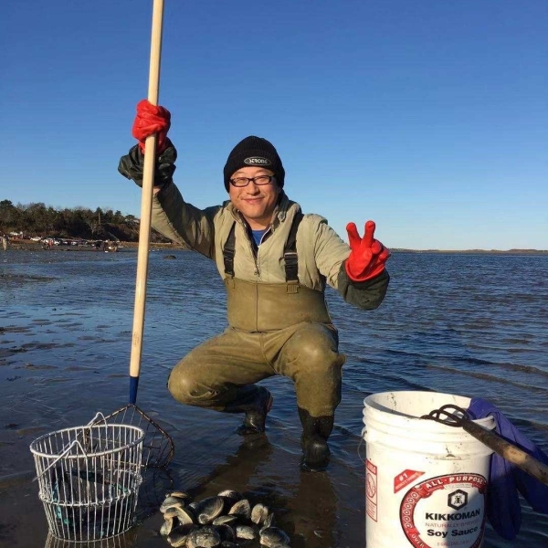 Insulet employee Xianjun standing in waters fish