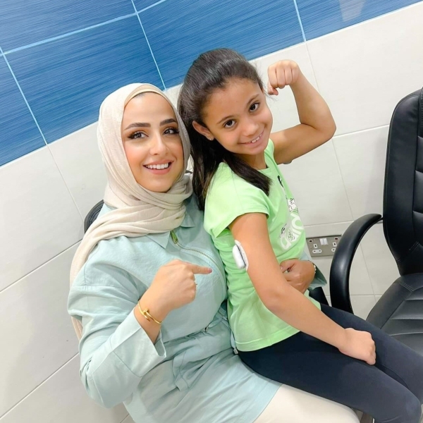 Little girl flexing her left arm bicep